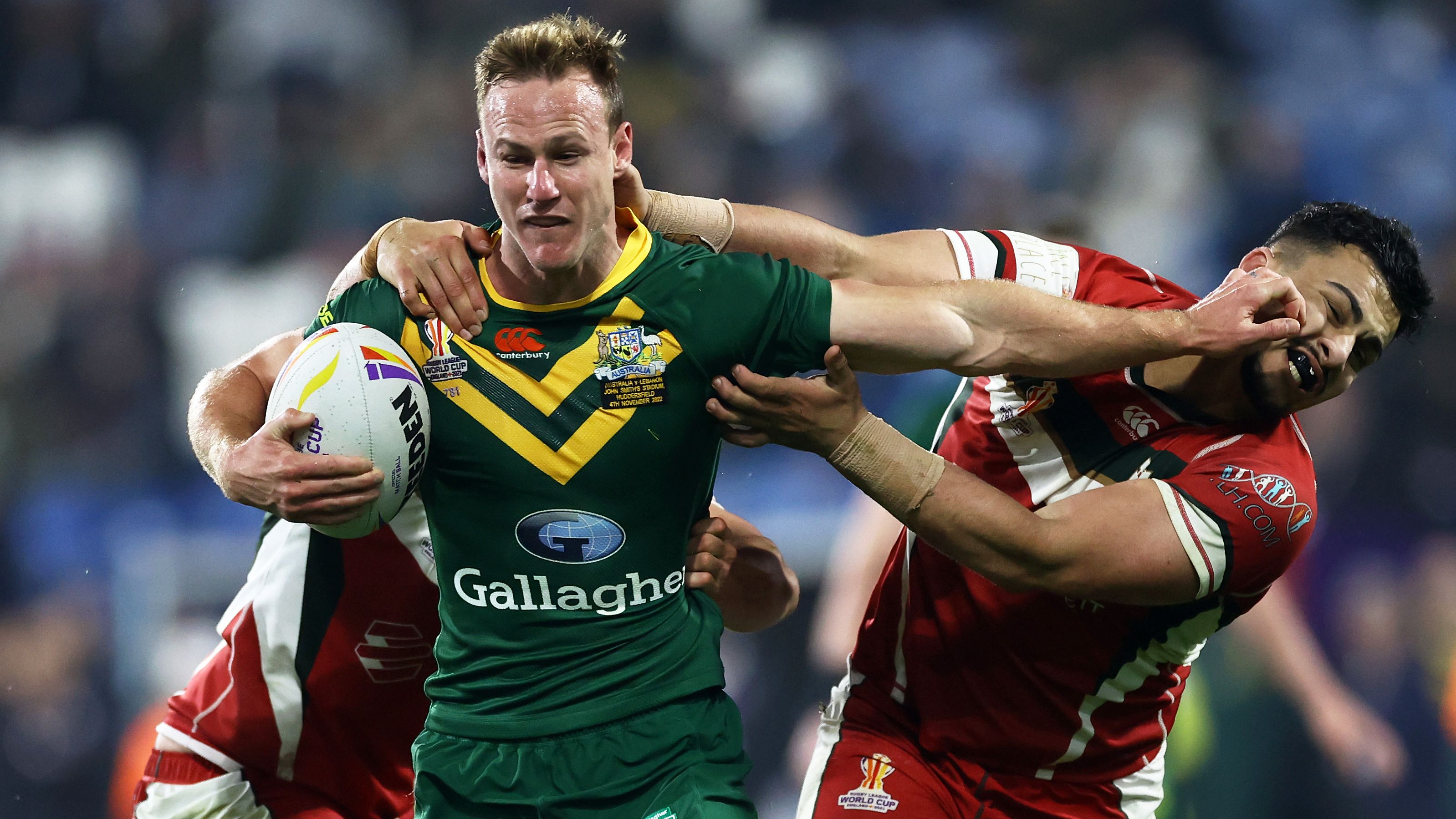 Daly Cherry-Evans holds off Charbel Tasipale of Lebanon during theIR Rugby League World Cup quarterfinal.