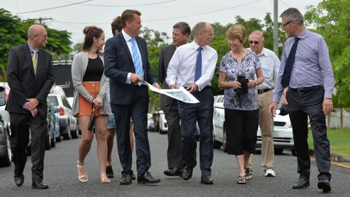 Scott Emerson and Queensland premier Campbell Newman chat to members of the public with Aaron Dillaway Member for Bulimba, outside Cannon Hill railway station during the Queensland state election campaign in Brisbane. (AAP)