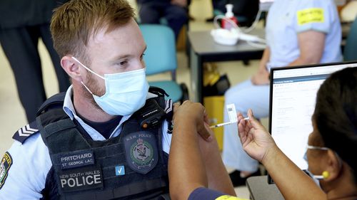 New South Wales Police officer Lachlan Pritchard receives the Pfizer vaccine at the Royal Prince Alfred Hospital Vaccination Hub in Sydney.