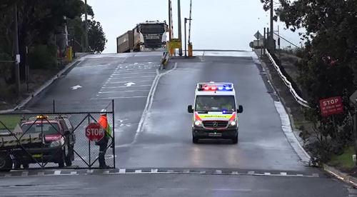 A man was dropping a load of coal at a Port Kembla terminal when his truck rolled causing his leg to be severed.