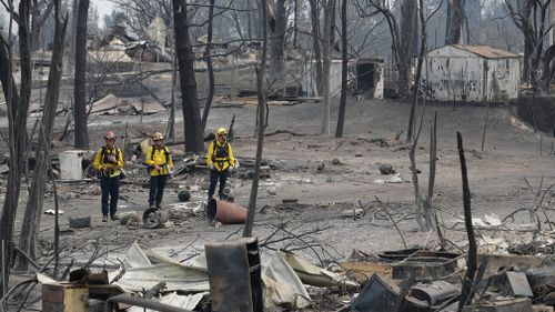 Much of the landscape has been reduced to blackened trees and smouldering rubble. Picture: AP