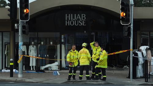 NSW fire department stand in front of the shop Hijab House in Sydney where a car drove into the shop, injuring twelve people including the driver.