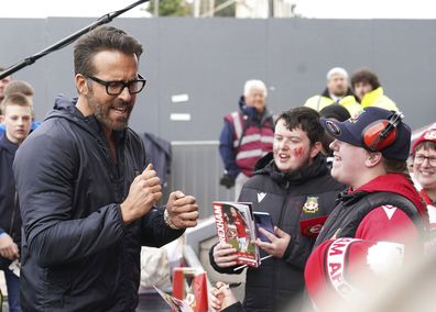 Wrexham co-owner Ryan Reynolds reacts with fans ahead of the National League soccer match between Wrexham and Boreham Wood at The Racecourse Ground, in Wrexham, Wales, Saturday April 22, 2023.