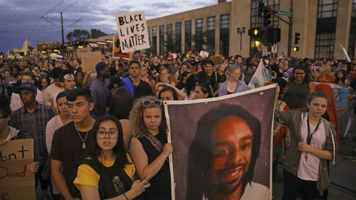 Demonstrators march to remember Philando Castile. (AAP)