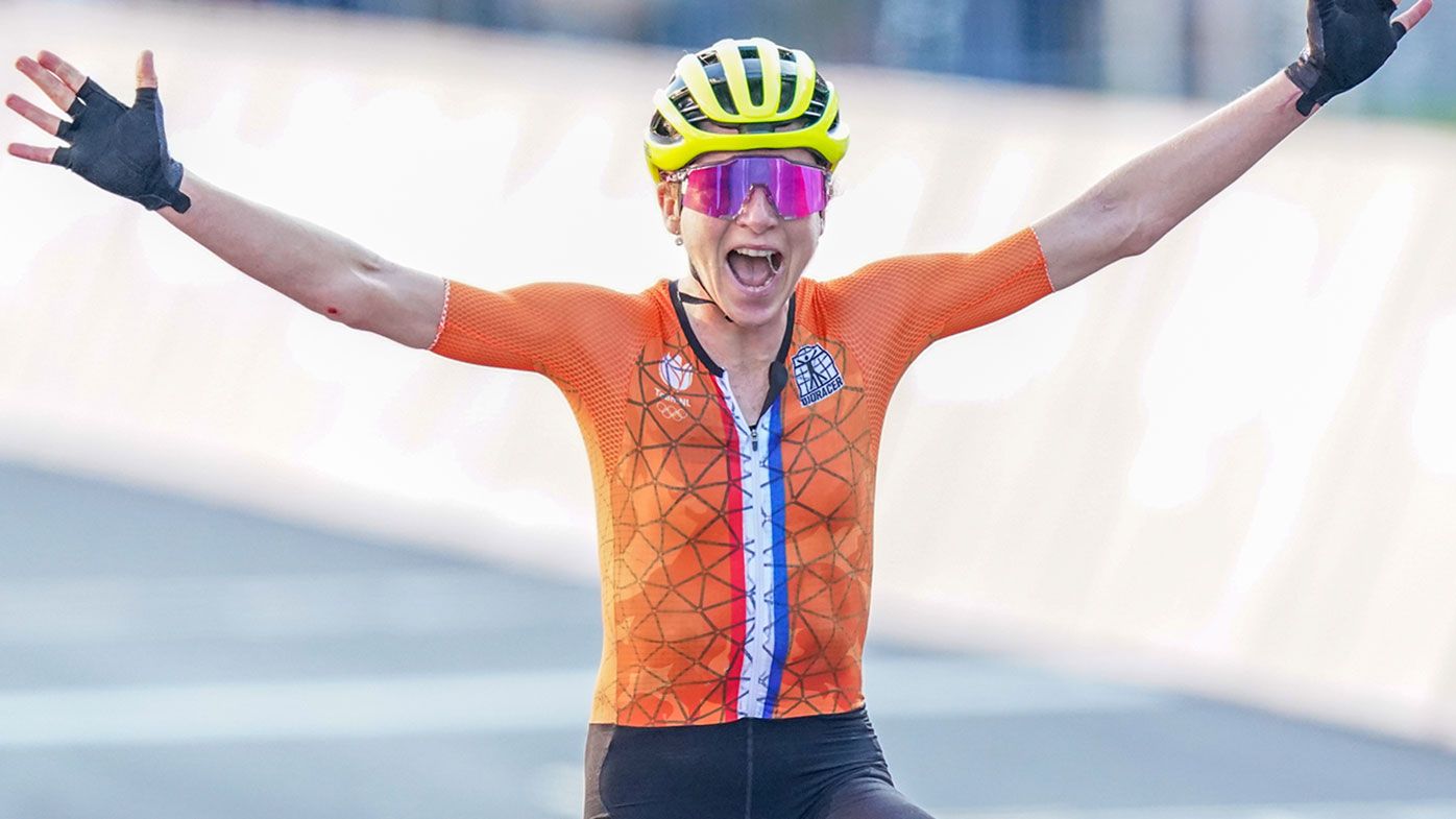 Annemiek van Vleuten celebrates as she crosses the line in the women&#x27;s road race at the Tokyo Olympics.