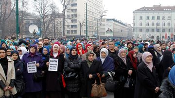 Marchers protest the decision to ban the display of religious symbols by employees of judicial institutions in Bosnia and Herzegovina. (AFP)