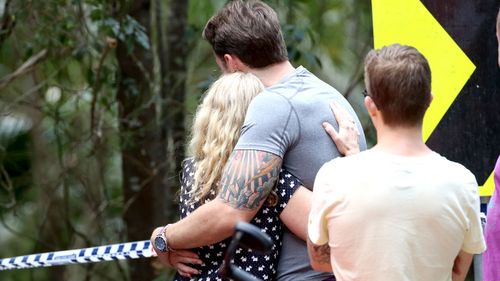 Faye Leveson (left), the mother of Matthew Leveson, is consoled by a friend at the site. (AAP)