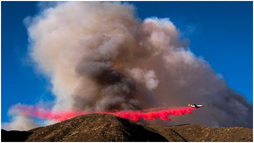 An air tank drops fire retardant over the Blue Cut wildfire. (AFP)