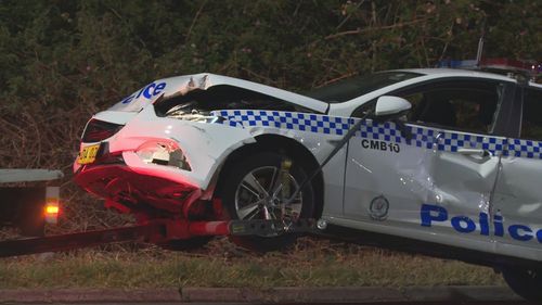 A man in an allegedly stolen truck has left a trail of destruction across Western Sydney after ramming into police cars and hitting a school crossing.