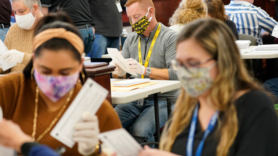 Municipal workers extract Luzerne County ballots from their envelopes, Wednesday, Nov. 4, 2020, in Wilkes-Barre, Pa. (AP Photo/Mary Altaffer)