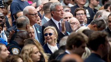 Hillary Clinton (centre), stands in front of New York mayor Bill de Blasio during the September 11 memorial. (AP)
