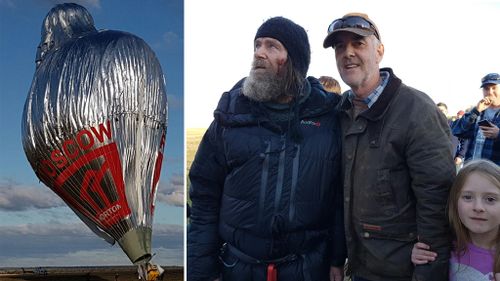 The balloon landing, and Fedor Konyukhov (left), among crowds on the ground. (Supplied)