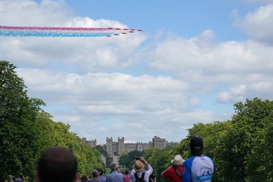 The Red Arrows fly over Windsor Castle to mark the official birthday of Queen Elizabeth.