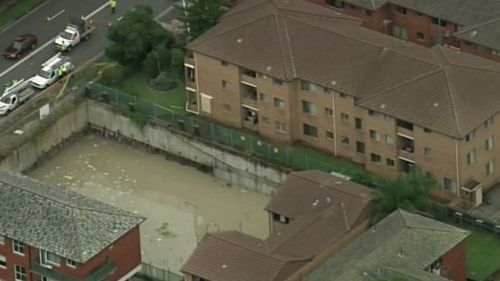 The sinkholes spread from a flooded building site nearby. (9NEWS)