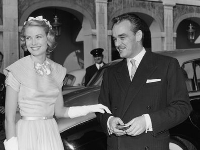 Prince Rainier of Monaco and his wife-to-be Princess Grace (1929 - 1982) greet well-wishers in the palace courtyard in Monte Carlo prior to their wedding, 18th April 1956. (Photo by Reg Birkett/Keystone/Hulton Archive/Getty Images)