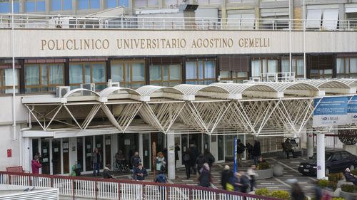 People arrive and leave the Agostino Gemelli Polyclinic in Rome, Friday, Feb. 14, 2025, where Pope Francis has been hospitalised to undergo a necessary diagnostic tests and to continue his ongoing treatment for bronchitis. (AP Photo/Andrew Medichini)