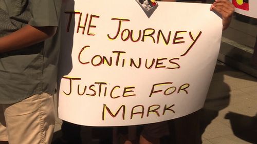 Family and friends held signs, 30 years after Mark Haines' death. (9NEWS)