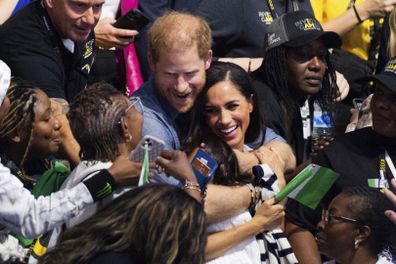 Britain's Prince Harry and Meghan, The Duchess of Sussex, watch sitting volleyball between fans from Nigeria and Ukraine at the 6th Invictus Games in Duesseldorf, Germany, Thursday, Sept. 14, 2023. Harry founded the Invictus Games to aid the rehabilitation of service members and veterans by giving them the challenge of competing in sports events similar to the Paralympics. (Rolf Vennenbernd/dpa via AP)