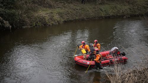 A search dog from Lancashire Police and a crew from Lancashire Fire and Rescue service search the River Wyre for missing woman Nicola Bulley in the village of St Michael's on Wyre, UK.