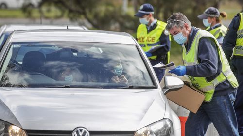 Canberra residents who have been stranded at the Victorian/NSW border arrive at a police checkpoint at Hall, at the NSW/ACT border, on Thursday 13 August 2020. 