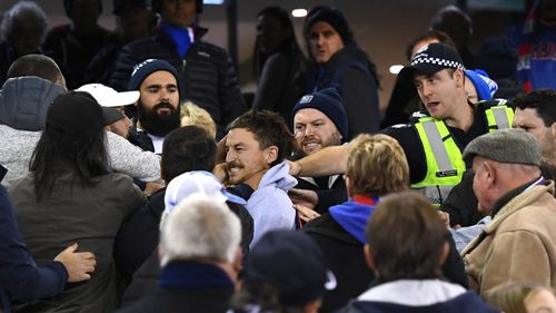 Fans brawl after the final siren of the Carlton-Western Bulldogs thriller.