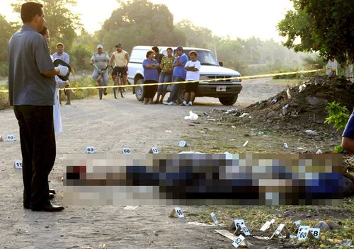 Mexican Police at a crime scene where five dead people were found, believed killed by the Sinaloa cartel.