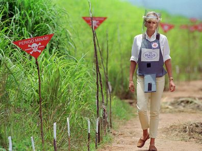 Princess Diana walks through a cleared landmine field in Angola, 1997.