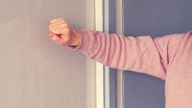 woman knocking on front door