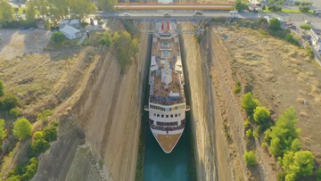 A 22.5-metre-wide cruise liner carrying more than 900 passengers squeezed through the Corinth Canal