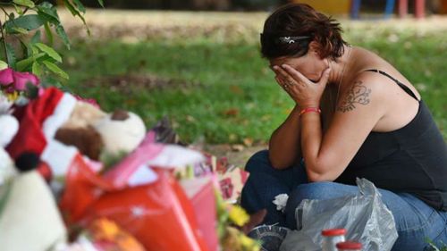 A woman grieves at the memorial site.