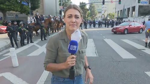 Lauren Tomasi was shot in the leg with a rubber bullet by one of the police officers over her right shoulder.