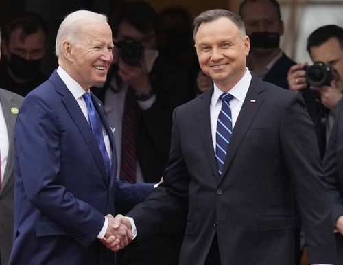 US President Joe Biden, left, and Polish President Andrzej Duda shake hands during a military welcome ceremony at the Presidential Palace in Warsaw, Poland, on Saturday, March 26, 2022. 