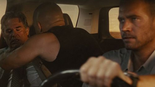 One scene required the digitally-created Walker to concentrate while driving at high speed, and checking on Kurt Russell's character in the back seat. (Universal Pictures)