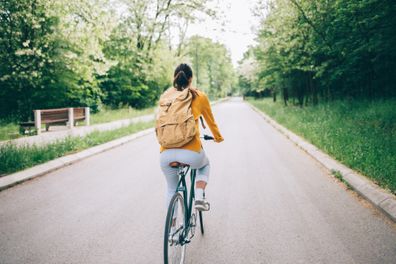 Rear view of woman cycling in the park.