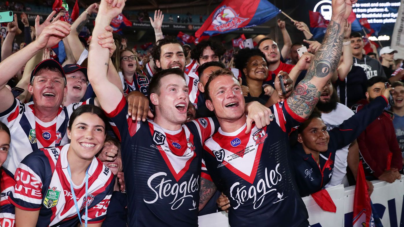 Luke Keary (L) and Jake Friend (R) of the Roosters celebrate victory with fans 
