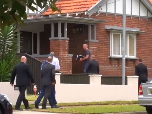 Police stand outside  the Belmore home of slain Martin Place terrorist Man Haron Monis. (9NEWS)