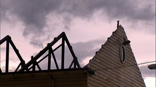 The ferocious storm cell left a community hall roof stripped bare. (9NEWS)