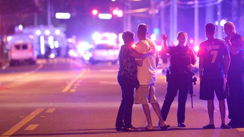 Orlando Police officers direct family members away from the scene. (AAP)