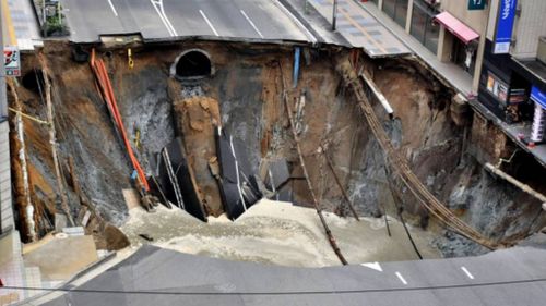 Massive sinkhole opens near train station in south Japan 
