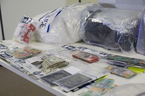 Drugs, passports and money are seen among other evidence during a police press conference in Melbourne. 