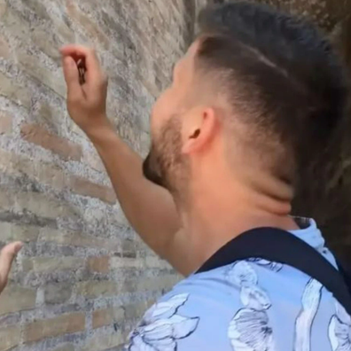 Tourist filmed carving names into Rome's Colosseum wall facing fine and prison time