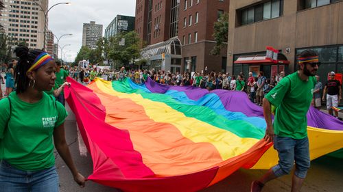 A giant pride flag is paraded down the main streets of Montreal. (AFP)