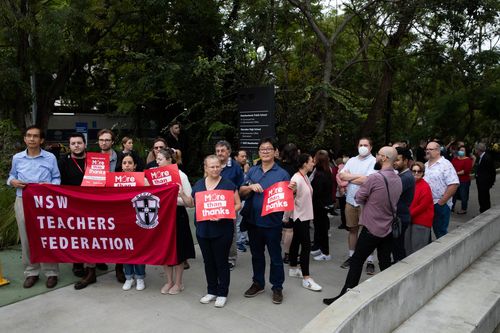 About 40 teachers from Marsden High School gathered outside of Meadowbank Public School holding signs which read "more than thanks".