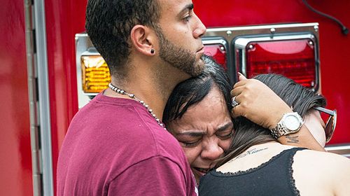 Friends and family grieve after a list of hospitalised victims was released, implying the death of those who weren't on the list and hadn't been heard from. (AAP)