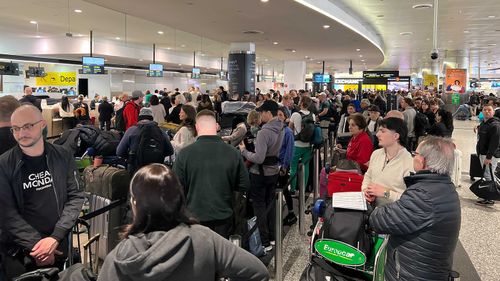 Long queues at Melbourne Airport's international terminal after an IT outage.