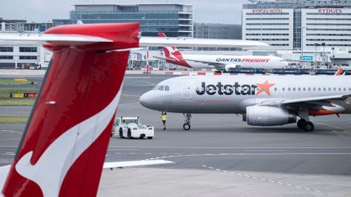 travel Qantas and Jetstar airplanes at Sydney domestic airport.