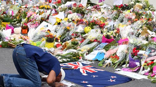 A muslim worshipper prays at a makeshift memorial at the Al Noor Mosque on Deans Rd in Christchurch, New Zealand.