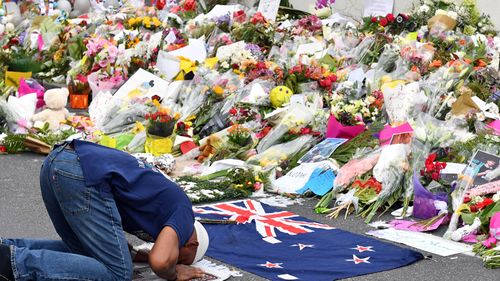 A Muslim worshipper prays at a makeshift memorial at the Al Noor Mosque.