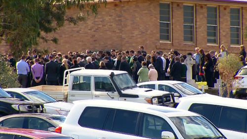 Hundreds of mourners gathered for Archie Hunt's funeral today. (9NEWS)