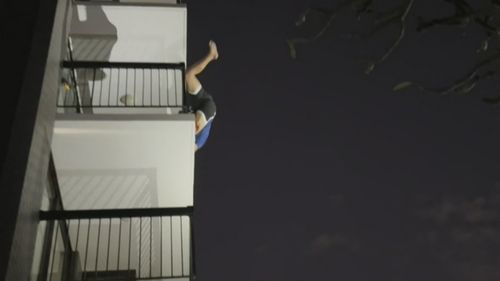 A man has leapt off a Gold Coast balcony and swung into a neighbouring unit during a chase with police.